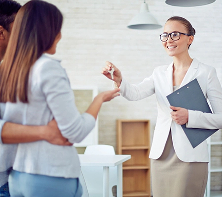 A woman is shaking hands with another person.