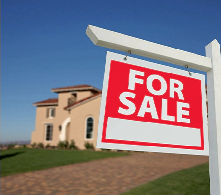 A for sale sign in front of a house.