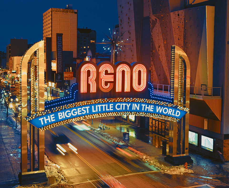 A neon sign that reads " reno the biggest little city in the world ".