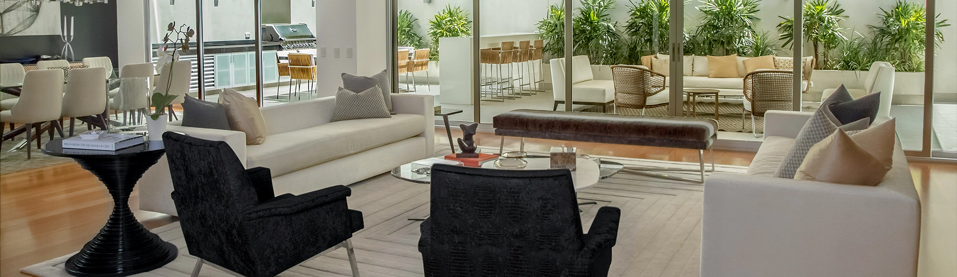 A living room with furniture and potted plants.